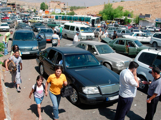 Travelers block the road, at the Masnaa border, between Lebanon and Syria, on the outskirts of the Bekaa Valley, east of Beirut on Monday.