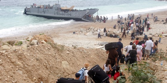 Americans hauled luggage towards a U.S. landing craft at a beach in Beirut, Lebanon, as the international exodus from besieged Lebanon reached a peak.