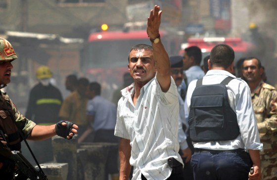 Iraqi man gestures at site of bomb attack in northern city of Kirkuk
