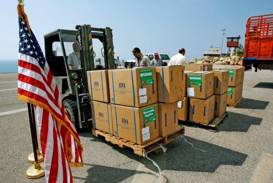 Workers move boxes of aid in the U.S. embassy in Beirut on Tuesday.