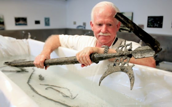 William Kelso, director of archaeology for the Association for the Preservation of Virginia Antiquities, holds one of the artifacts recovered Tuesday, July, 25, 2006, in Jamestown, Va. Kelso is holding a halberd, a 17th century ceremonial staff often carried by military sergeants. The find also includes a hammer and an intact ceramic bottle called a Bartmann jug or a "bearded man," which was made in Germany and could date back to 1590, Kelso said.