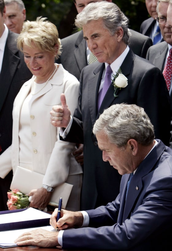US President George W Bush signs the Adam Walsh Child Protection and Safety Act at the White House in Washington