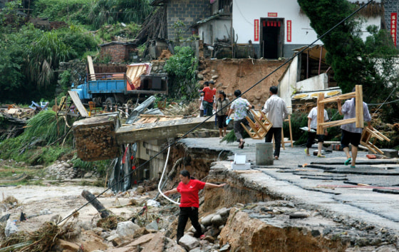 Residents of Shangyou, in southern China's Jiangxi province, salvage their belongings following Typhoon Kaemi. Mobile phone messages have become a key tool for Chinese authorities who need to alert millions of villagers and fishermen during this year's unusually powerful typhoon season.