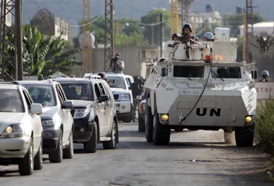 United Nations peacekeepers on an armoured personnel carrier lead a convoy of cars outside the U.N headquarters on the outskirts of the southern border town of Naqoura, Lebanon, on Friday.