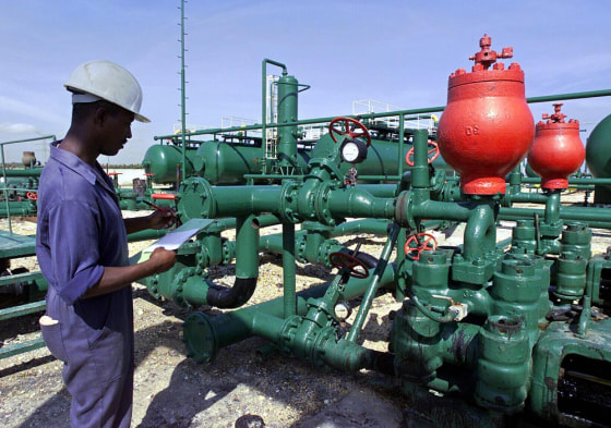 An employee works at the oil central pla
