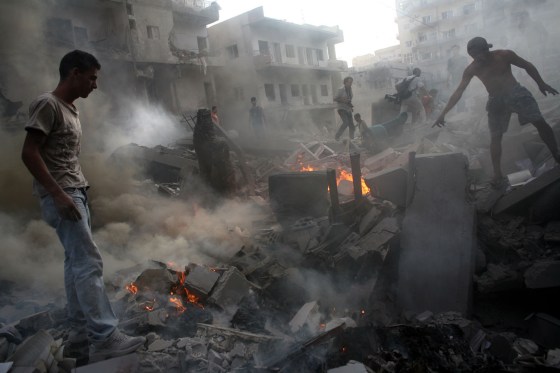Residents of the Lebanese city of Tyre explore the ruins of a building destroyed by Israeli warplanes on July 26. There were 16 injuries in the attack on what is believed to be a community center or offices affiliated with Hezbollah. 