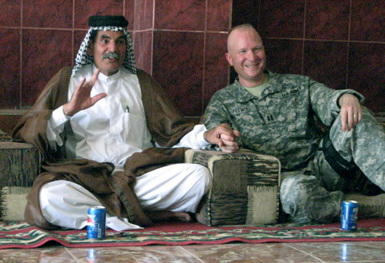 Capt. Colin Fleming of the 34th Infantry Division of the Minnesota National Guard, right, talks Tuesday with Sheik Chiad Hamood Al-Guam in the southern Iraqi village of Abu Tubar.