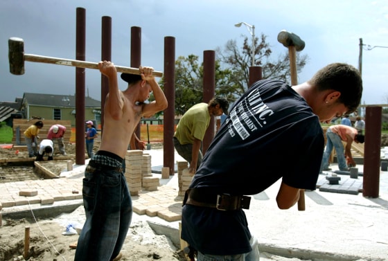 Workers swing sledge hammers during the construction on a monument to victims of Hurricane Katrina in New Orleans
