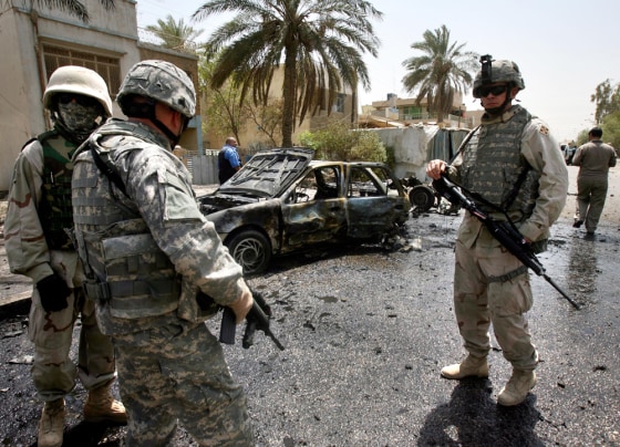 U.S. soldiers inspect the site of a car bomb explosion in Baghdad on Thursday.