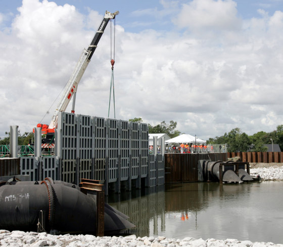 Sections of new flood gates are lowered into the London Ave. Canal during a demonstration in New Orleans on Saturday. Levees along the canal failed during Hurricane Katrina.