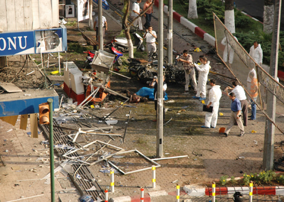 Police officers survey damage following