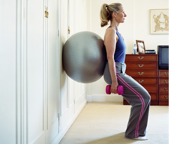 An exercise ball and some hand weights can help you get a good workout at home without breaking the bank.