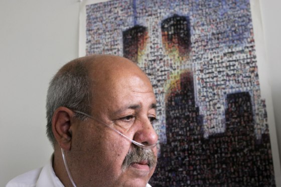 Richard Pecorella, who uses tubes to help him breathe as a result of emphysema, sits next to a bookshelf that bears tribute to the memory of his fiance, Karen Juday, who died in the Sept. 11, 2001, attacks. Pecorella believes the weeks he spent walking through smoke and dust around ground zero, searching for Juday, contributed to the onset of his disease.