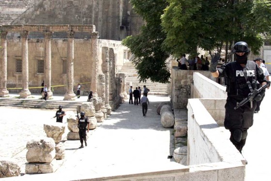 Jordanian policemen secure the area where a gunman opened fire on foreign tourists in Amman on Monday.