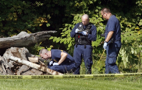 Detectives Her Leighton, left, Scott Gosselin, center, and Mark Lopez look for clues in Newry, Maine, where the bodies of three women were found.