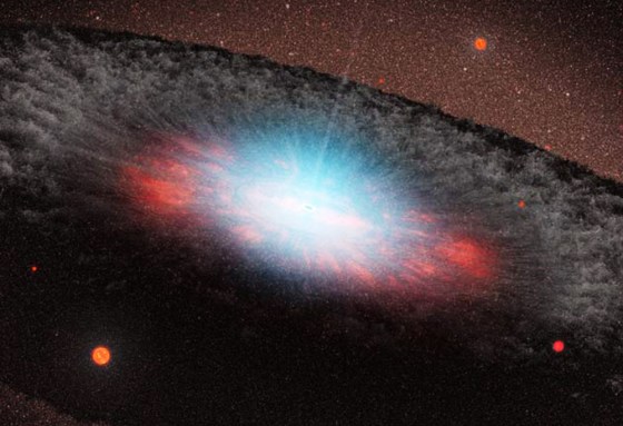 An artist's conception shows a supermassive black hole at the center of a galaxy. Blue color represents radiation pouring out from material very close to the black hole. The grayish structure surrounding the black hole, called a torus, is made up of gas and dust. Beyond the torus, only the old red-colored stars that make up the galaxy can be seen. There are no new stars in the galaxy.