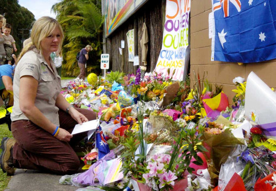 Australia Zoo's hospital wildlife manager Gail Gipp looks at the display of flowers in memory of 'Crocodile Hunter' Steve Irwin on Tuesday. People around the world expressed their grief Monday upon hearing of the renowned environmentalist's death.