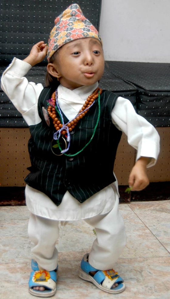 Khagendra Thapa Magar, 14, dances in Baglung village, 169 miles west of Katmandu, Nepal, on Monday, April 17. Magar, who is only 20 inches tall and weighs 10 pounds had hoped to be named the shortest person in the world. 
