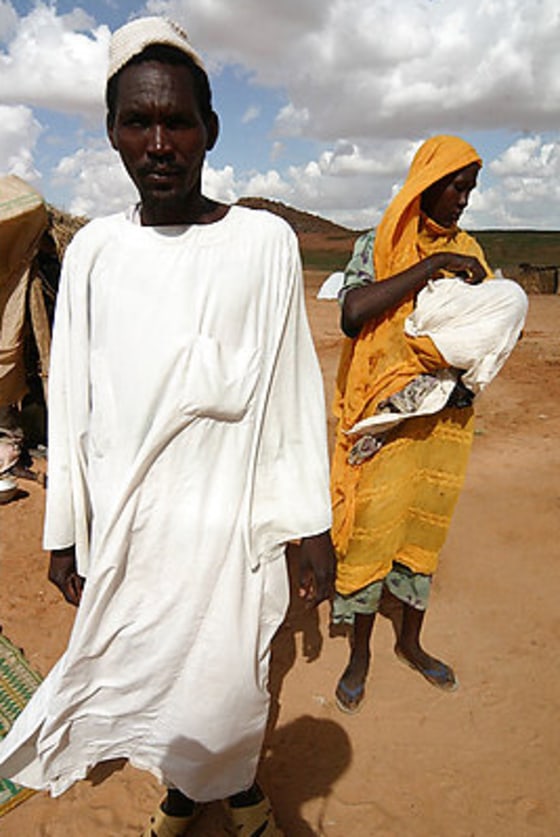 Adouma Ahmed Khames, 35, his wife Kaldoum Adam Ahmed, 32, and their baby daughter Rihad are seen in El Fasher, Sudan, on Tuesday, after surviving a brutal attack on their village in July.