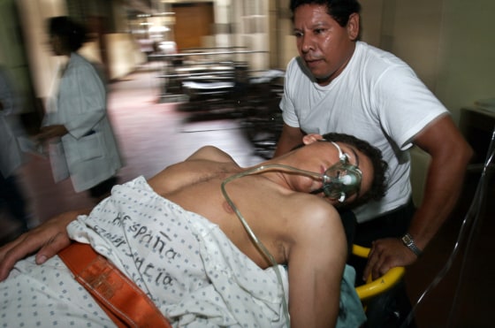 A medic pushes a victim of home brewed liquor laced with methanol into the emergency room at the Oscar Danilo Rosales Hospital School in Leon, west of Managua, Nicaragua, on Sunday.The government said 27 people had died. More deaths are expected.