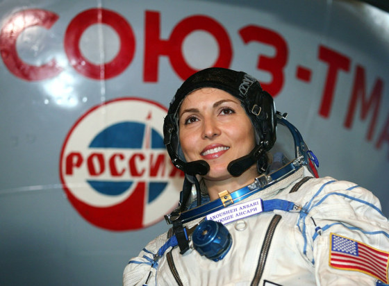 U.S. entrepeneur Anousheh Ansari stands in front of a Soyuz space capsule training module during an examination on how to operate the Soyuz space capsule in the Star City space centre
