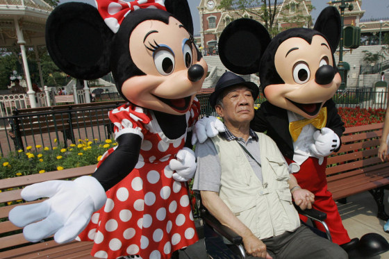 An elderly tourist has his picture taken