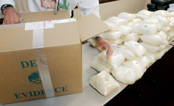 A U.S. Drug Enforcement Administration official shows some of the 187 pounds of "ice" seized along with 41 kilos of cocaine at a house in Buford, Ga., on Aug. 16. Although the case remains under investigation, authorities say the size of the stash points to Mexican drug cartel involvement.