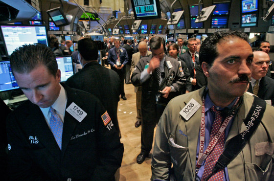 Workers on the floor of the New York Stock Exchange observe a moment of silence before Monday’s opening bell to observe the fifth anniversary of Sept. 11, 2001.
