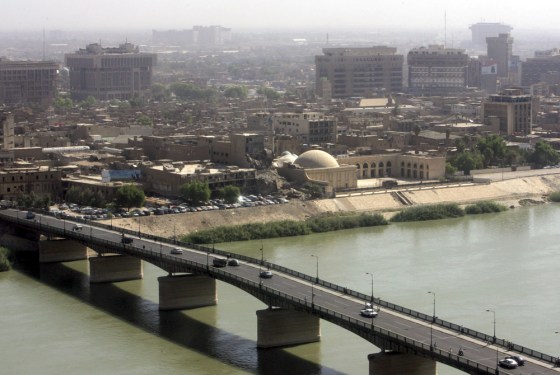 Cars are drive across a bridge above the Tigris river in Baghdad