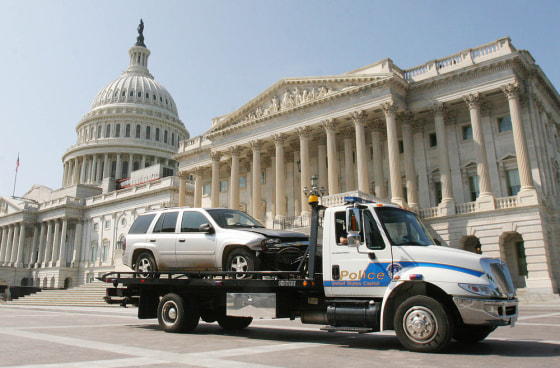 A vehicle that breached a barricade at the Capitol is towed away on Capitol Hill in Washington, D.C., on Monday.
