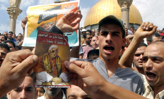 Palestinian Muslims hold up portraits during demonstration against Pope Benedict's remarks in Jerusalem
