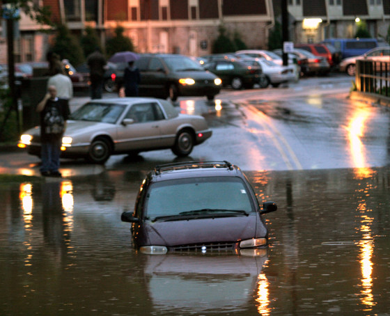 A van sits in high water in the Buechel neighborhood of Louisville, Ky., on Saturday. Up to 10 inches of rain fell across parts of the Midwest and South, and more wind and rain was expected.