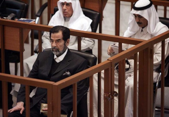 Saddam Hussein, Hussein Rashid Mohammed (back), former deputy director of operations for the Iraqi Armed Forces, and Farhan Mutlaq Saleh (R), former head of Military Intelligence's Eastern Regional Office, sit in the court during their trial in Baghdad September 25, 2006. Saddam was back in court in Baghdad on Monday for the latest hearing in his trial for genocide against ethnic Kurds but his defence lawyers stayed away in protest after the Iraqi government fired the judge.