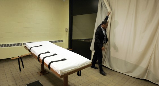 In this November 2005 photo, public information director Larry Greene shows how a curtain is pulled between the death chamber and witness room at Southern Ohio Corrections Facility in Lucasville, Ohio. The facility maintains detailed logs of Death Row inmates' last days.