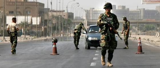 The Iraqi army mans a checkpoint in Baghdad on Saturday after the Iraqi government ordered a ban in Baghdad to pedestrian and car traffic through Sunday morning.