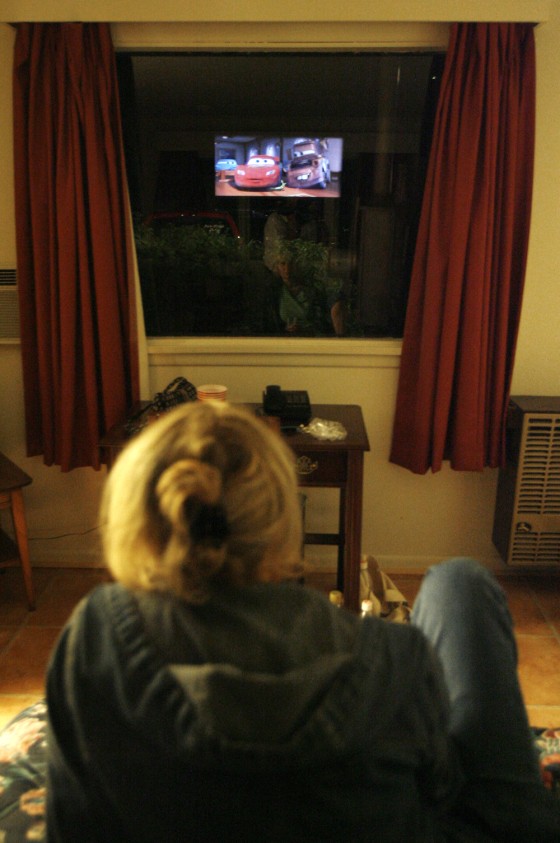 A patron watches from a room during the feature at the Fairlee Motel & Drive-In Theater in Fairlee, Vt. earlier this summer. At the Fairlee Motel & Drive-In Theater, you can drive in and have a classic outdoor experience, or check in and take in the same show from your king-size bed.