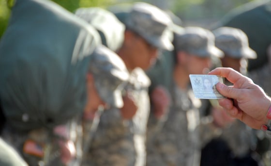 A drill sergeant calls out names of new cadets according to their identification card in April at Fort Knox, Ky.