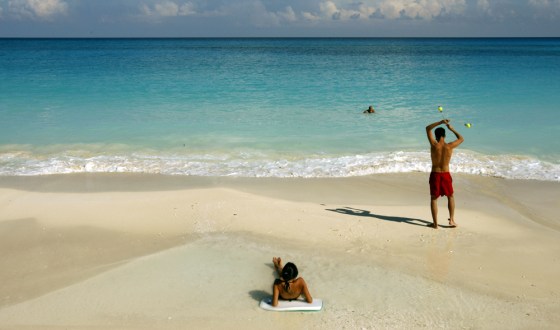 People enjoy the beach in Cancun, Mexico on Sept. 26. Cancun's new beach is the highlight of an extreme makeover the resort has gone through since it was savaged by Hurricane Wilma on Oct. 21, 2005.