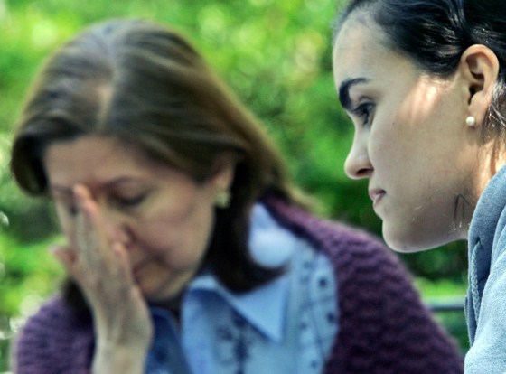 Sgt. Alessandro "Alex" Carbonaro's mother, Gilda Carbonaro, left, and his widow Gilda Carbonaro, right, reminisce after their meeting with the state representative in their back yard.