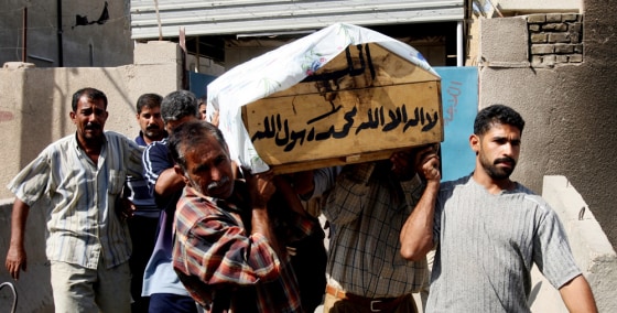 Relatives carry the coffin of Faisal Murtada outside a Baghdad hospital on Tuesday. Murtada, a handyman, was killed with two of his colleagues by unknown gunmen.
