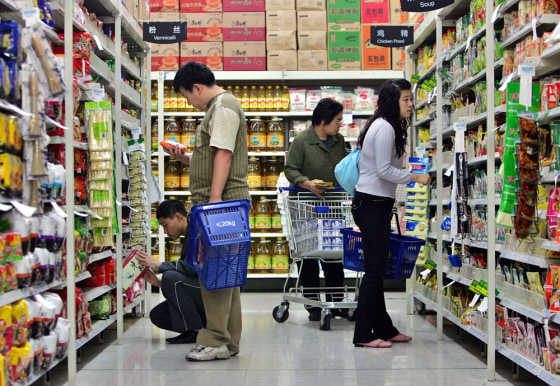 Customers shop at one of the outlets of the American supermarket Wal-Mart in Beijing, China. All of Wal-Mart’s 62 Chinese outlets have unions. Chinese law gives employees of any company with a work force of at least 25 people the right to form a union. Wal-Mart, which employs 30,000 people in China, has few unions elsewhere in its worldwide operations.