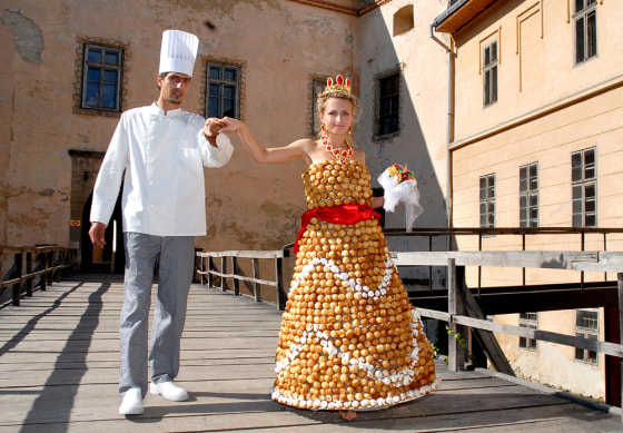 Baker Valentyn Shtefano and his bride Viktoriya show off her wedding gown, which Shtefano made out of flour, eggs, sugar and caramel, in the western Ukrainian city of Uzhhorod on Aug. 27.
