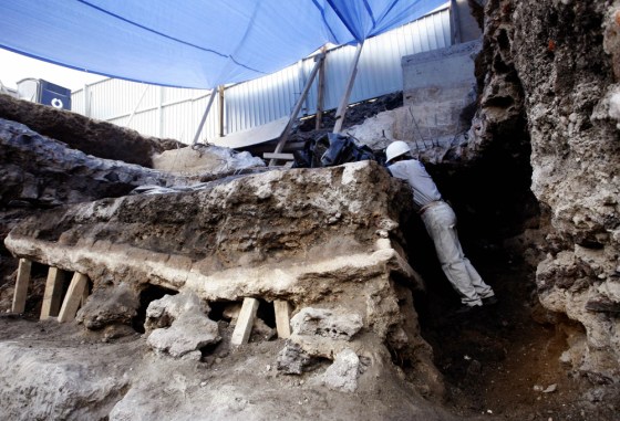 An archaeologist works inside a monolith that was discovered during excavations in the archaeological area of the Templo Mayor in Mexico City