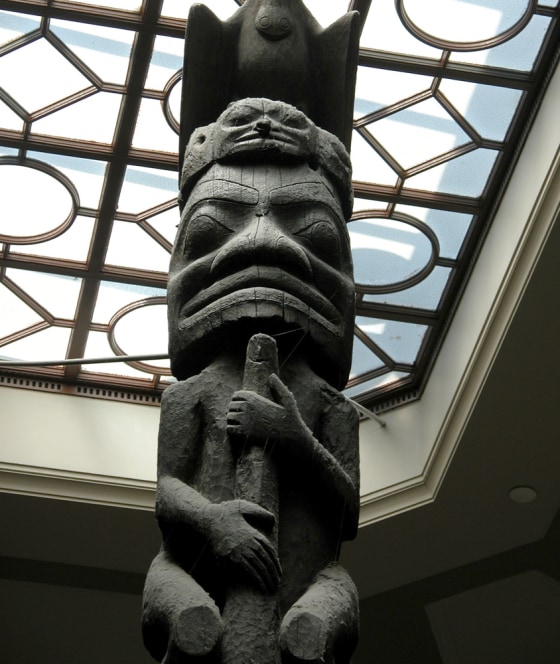 A totem pole extends towards the skylight in the main stairwell of the Royal Ontario Museum.