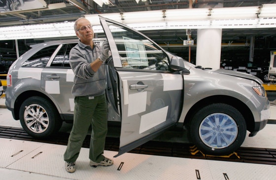 A Ford Motor Company employee inspects a new Ford Edge in Oakvile