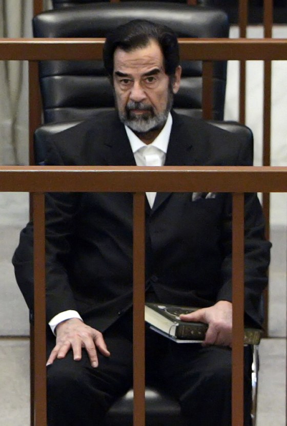 Holding a copy of the Holy Koran, ousted