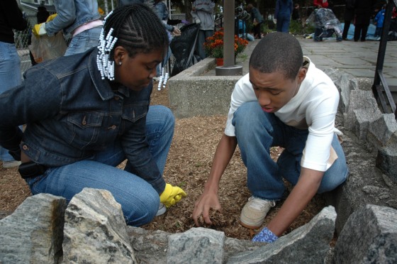 Olivia Smith, 14, and Shadrick Lester, 13, both 8th graders, pick up debris in the Wakefield neighborhood of the Bronx on Community Service Day.