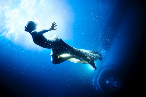 Actress and model Eva Mendez, dressed in a couture gown, swims in front of a Mercedes GL450 in an image called ‘The Sinking Fear.’