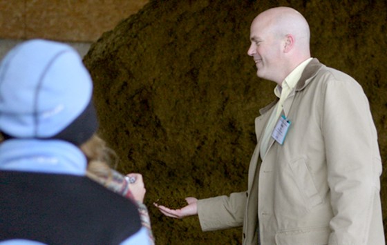 David Dunn, head Central Vermont Public Service's Cow Power program, holds a handful of manure solids left over after methane was extracted from raw manure. The process leaves a dry manure removed of pathogens and odor that is used as bedding for cows.