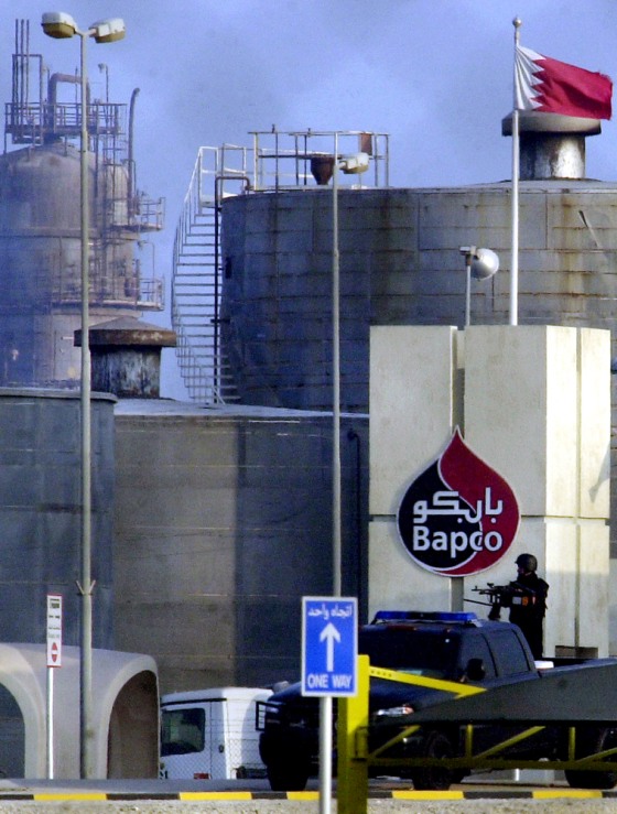 A Bahraini military commando stands guard on Thursday at the gates of an oil refinery in Sitra, Bahrain, belonging to the national petroleum company, Bapco.